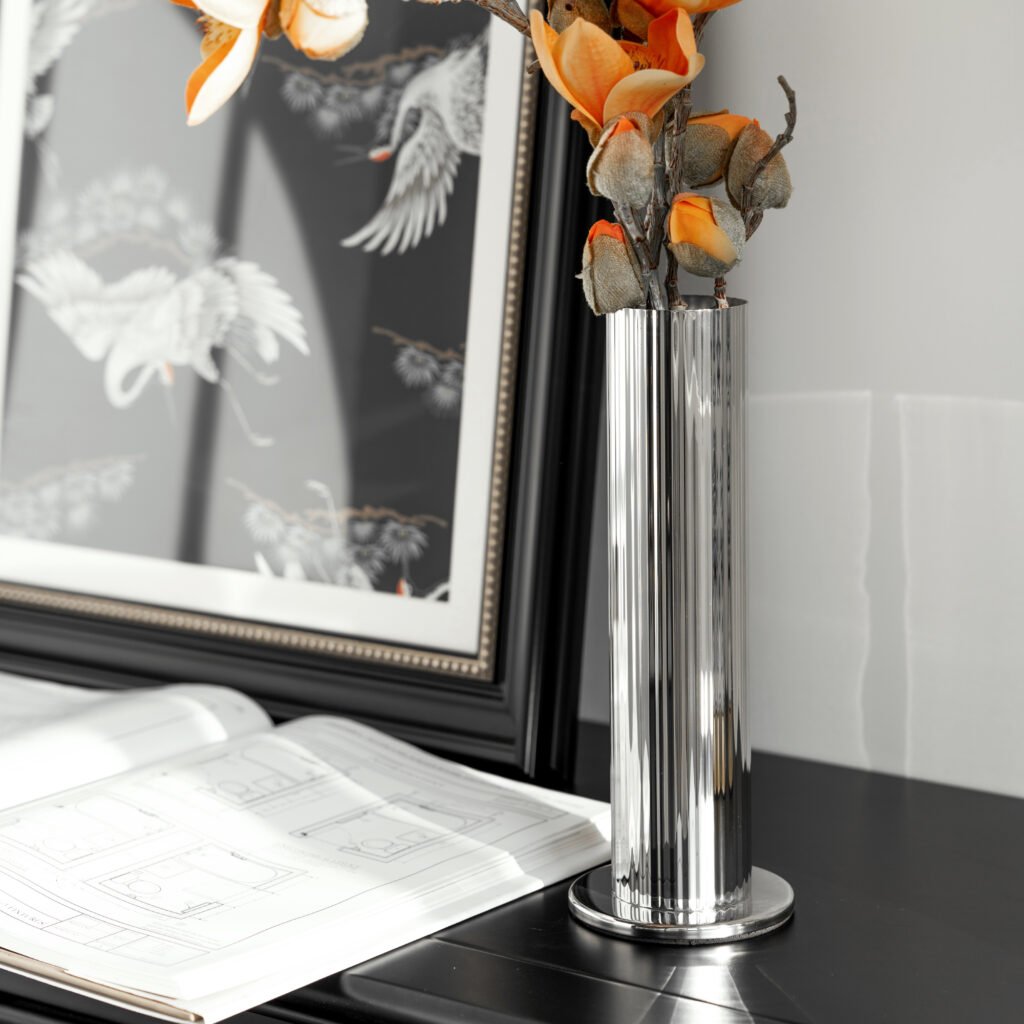 Close-up of the Modernist Textured Metalware, highlighting the precision-engineered flutes and the rhythmic light reflection across the steel ridges.