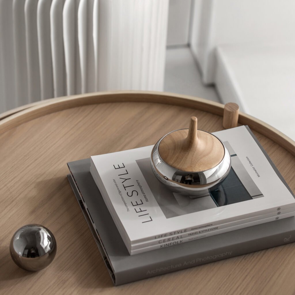 Steel Sculptural Vessel duo placed on a minimalist pedestal in a sunlit gallery, representing Reflective High-End Fluid Art elegance.