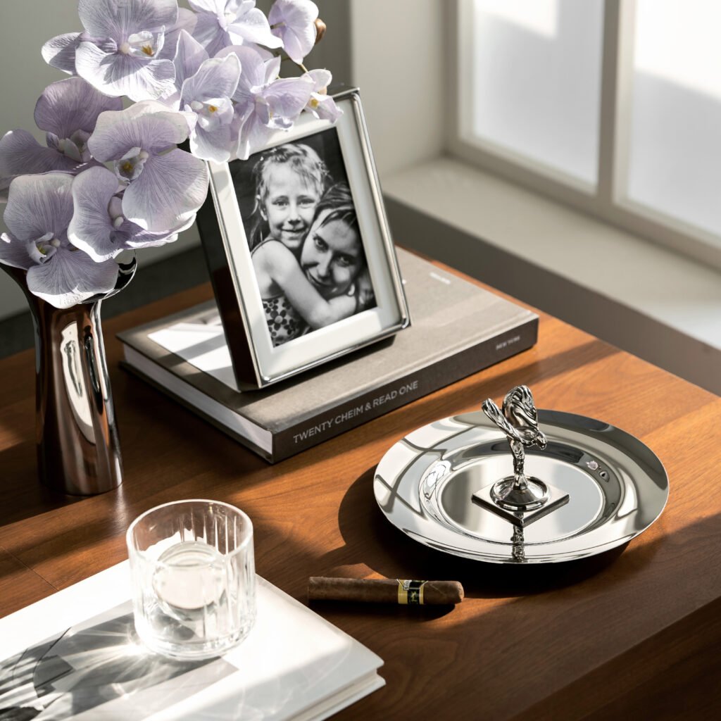 Steel Ultimate Cigar Dish placed on a hand-stitched leather console in a luxury vehicle interior, representing Reflective High-End Automotive Art elegance.