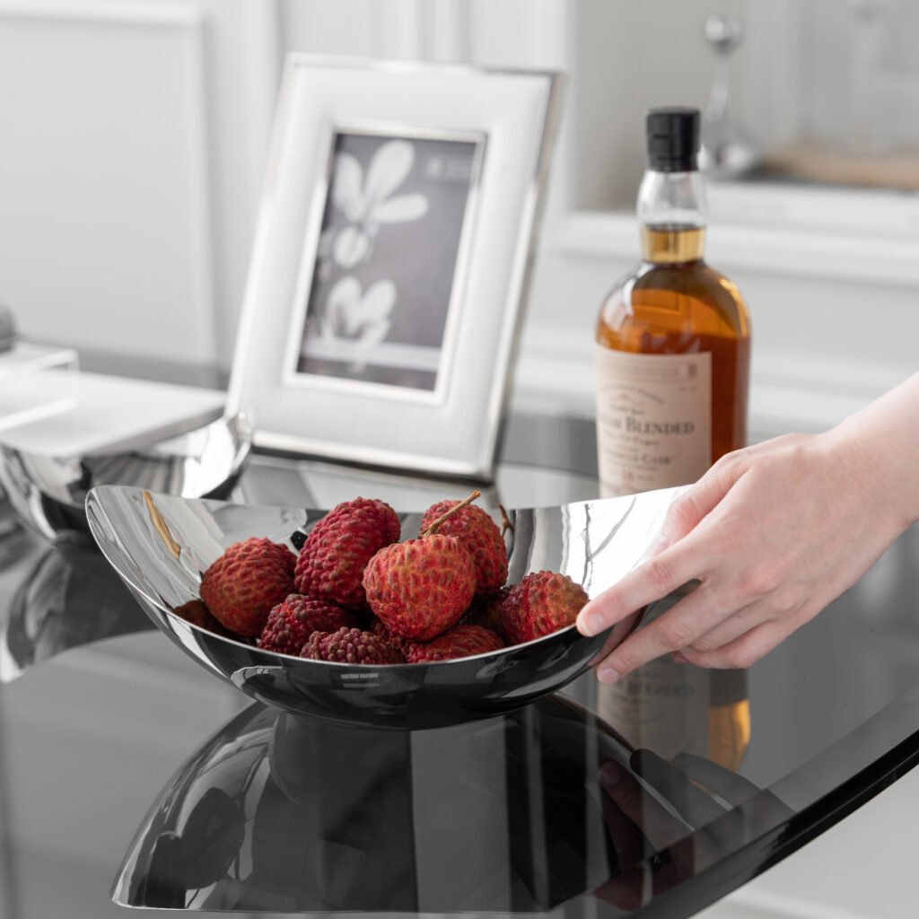 Close-up of the Modernist Asymmetrical Metalware, highlighting the precision-engineered angled edge and the expansive, high-clarity reflective interior.