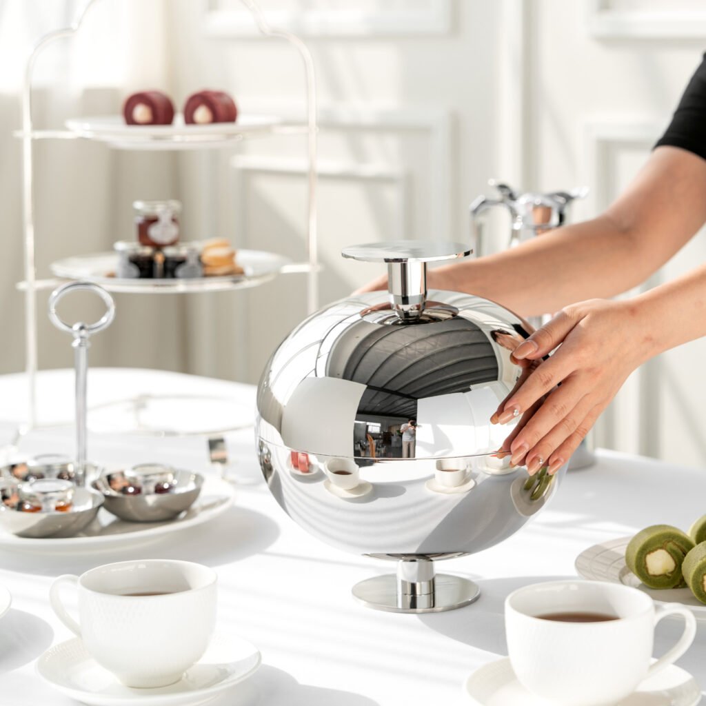 Steel Spherical Bowl (SS-64) featuring a deep, mirror-polished orb-like body with a sleek top opening for fruit, showcased as a Luxury Mirror Polished Orb Server.