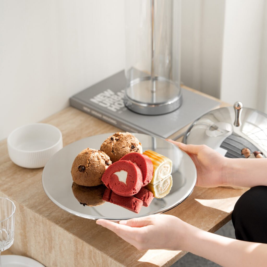 Steel Swirl Plate (SS-67) featuring a mirror-polished surface with a rhythmic radial swirl design, showcased as a Luxury Mirror Polished Mousse Dish.
