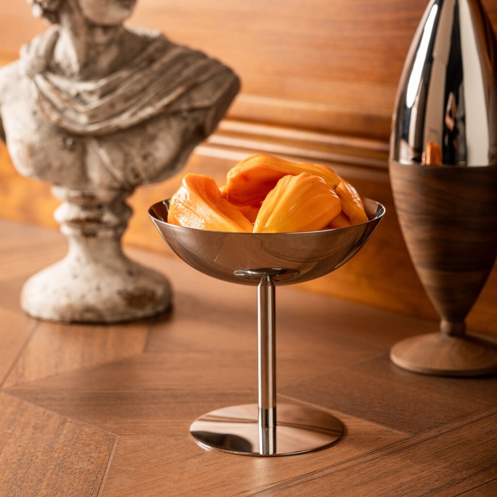 Close-up of the Modernist Pedestal Tableware, highlighting the thick-gauge steel rim and the flawless, panoramic reflective finish.