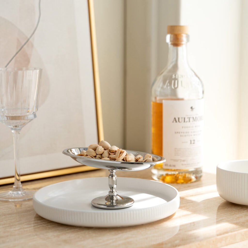 Steel Oval Cup placed on a slate serving board with a garnished panna cotta, representing Reflective Minimalist Dessert Art elegance.