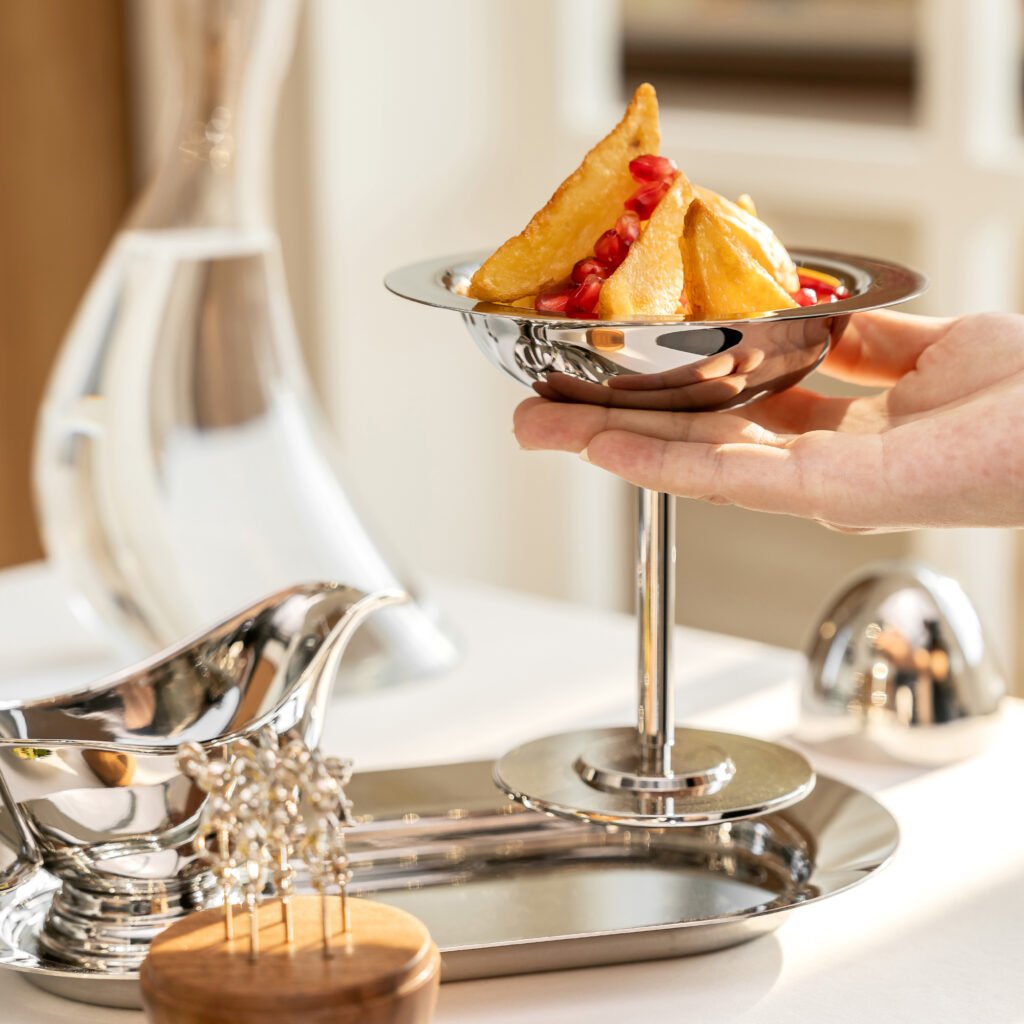 Steel Dessert Cup placed on a dark slate counter with an artisanal fruit parfait, representing Reflective Minimalist Serving Art elegance.