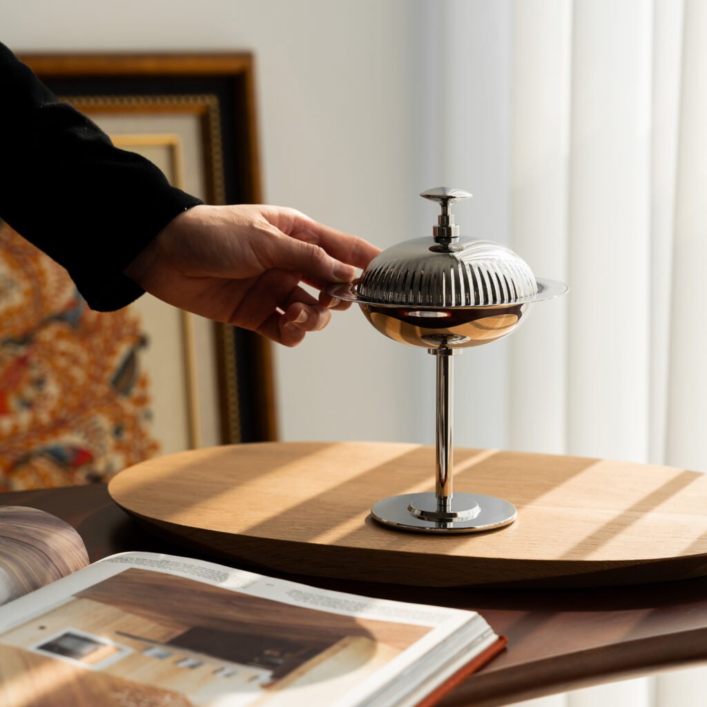Close-up of the Modernist Spherical Dessertware, highlighting the precision-fit lid and the flawless, deep-set reflective finish of the stainless steel.