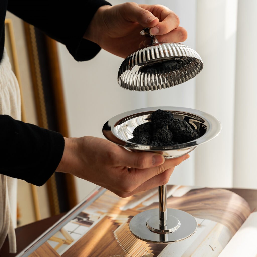 Steel Dessert Server placed on a dark slate tray, slightly opened to reveal a gourmet chocolate mousse, representing Reflective Fine Dining Art elegance.