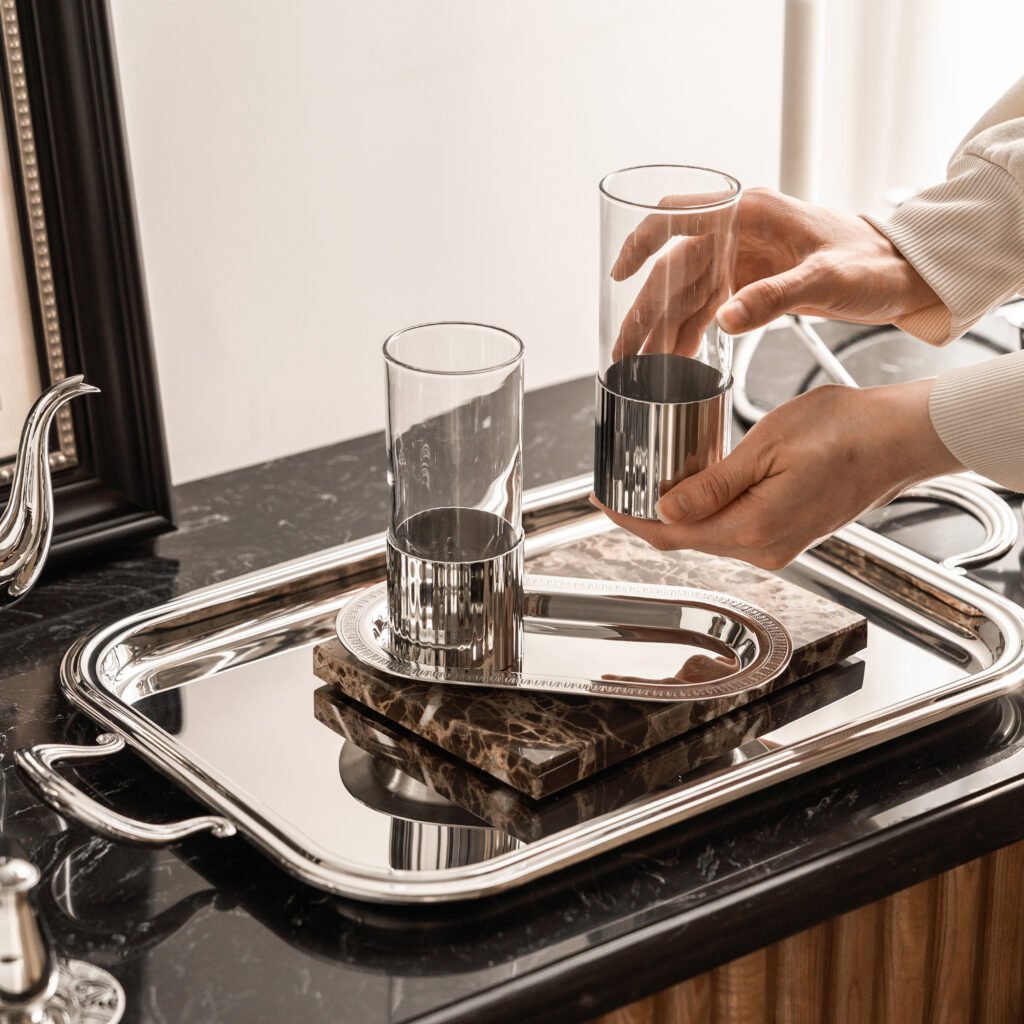 Close-up of the Modernist Retro Tableware, highlighting the thick-gauge steel rim and the flawless, deep-set reflective chrome finish of the cup.
