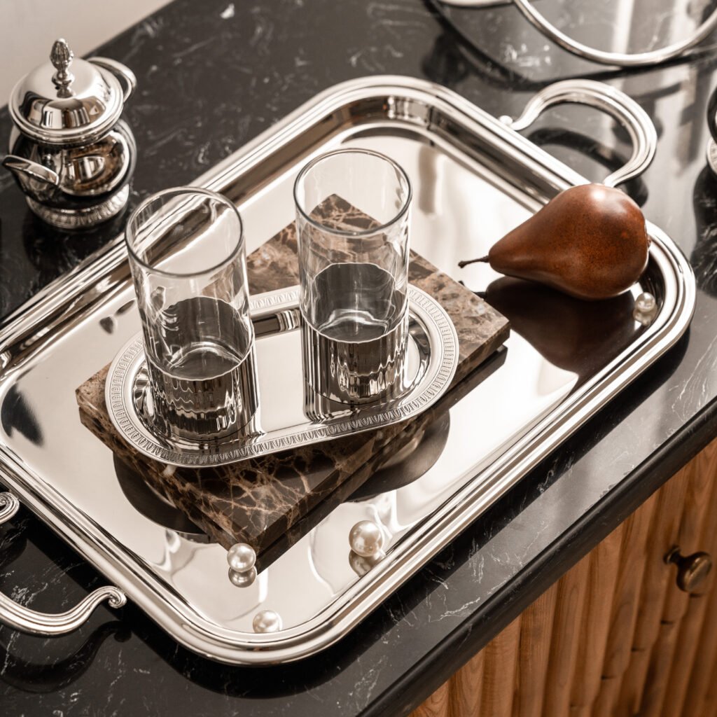 Steel Vintage Tumbler set placed on a dark leather bar top with a cocktail garnish, representing Reflective Industrial Serving Set elegance.