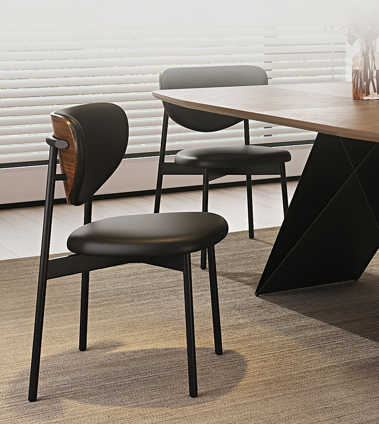 Close-up of an Apexerahomelife JX-DTS-003 dining chair highlighting the curved walnut backrest and ergonomic black upholstered seat.