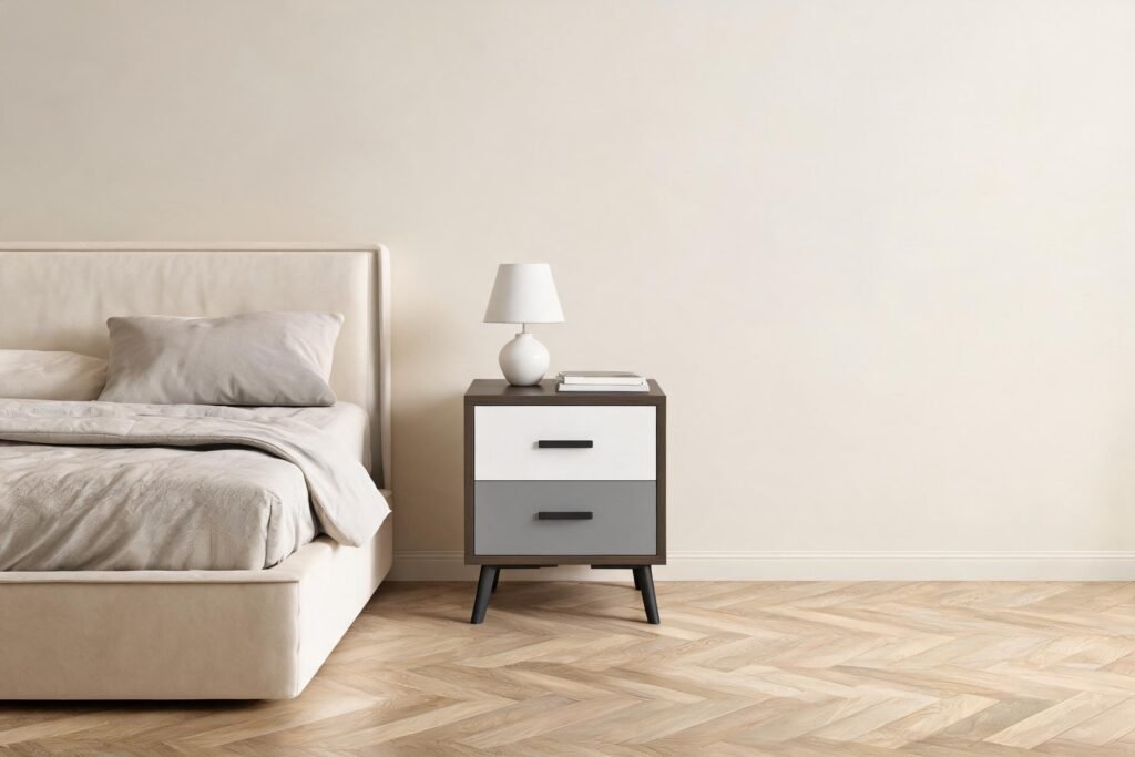 How tall should a nightstand be? This dark walnut nightstand with a white upper drawer and a grey lower drawer sits level with a low platform bed mattress in a warm cream bedroom