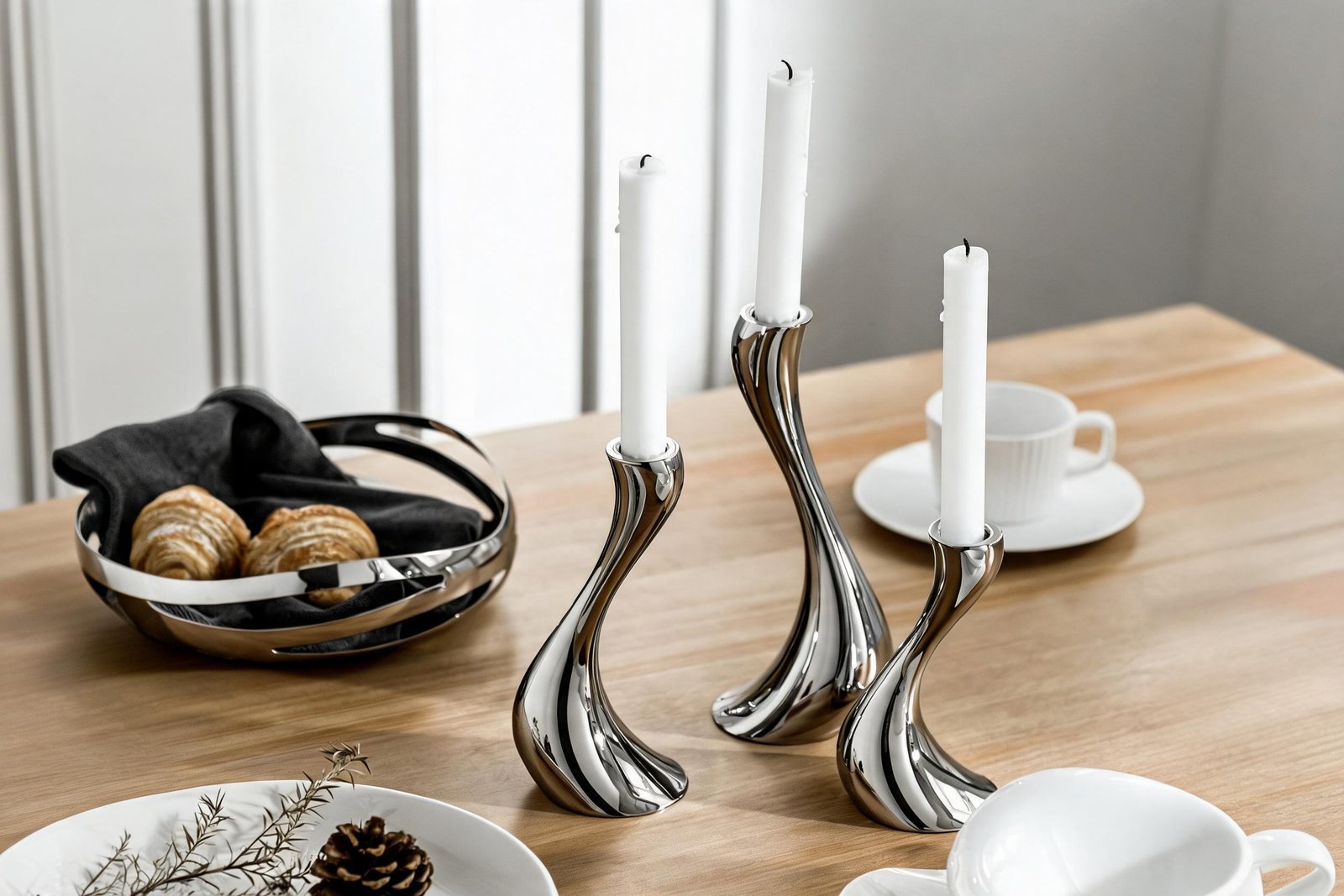 Mirror polished stainless steel S-curve candle holder set on a dining table