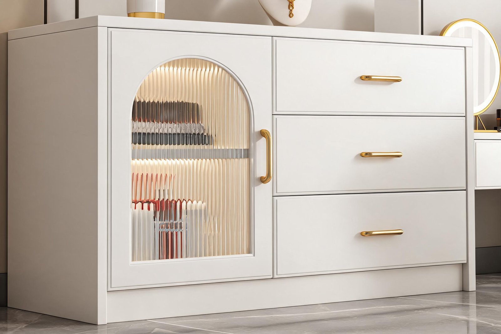 Close up of the fluted glass arched cabinet door and gold bar handle on a white vanity desk with built in LED vanity desk lighting behind the glass