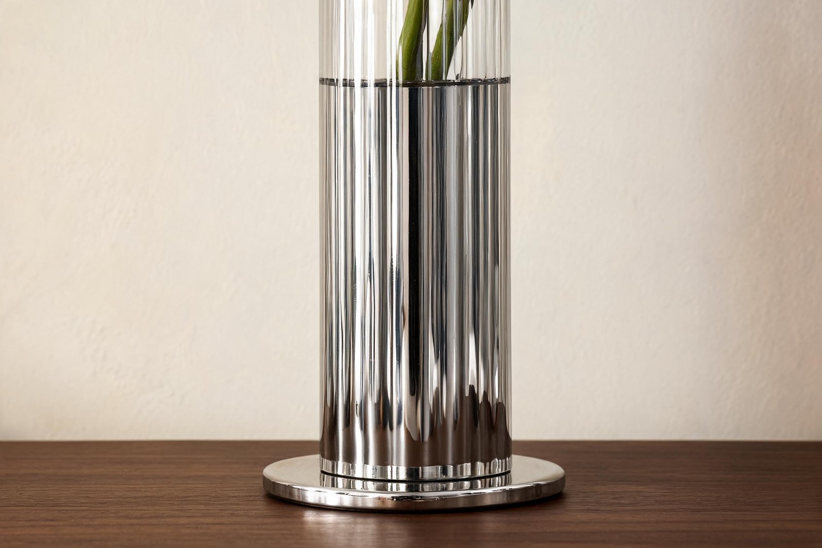 Vase height for dining table detail: vertical flutes and the flat disc base of a 10 by 27 cm mirror steel vase